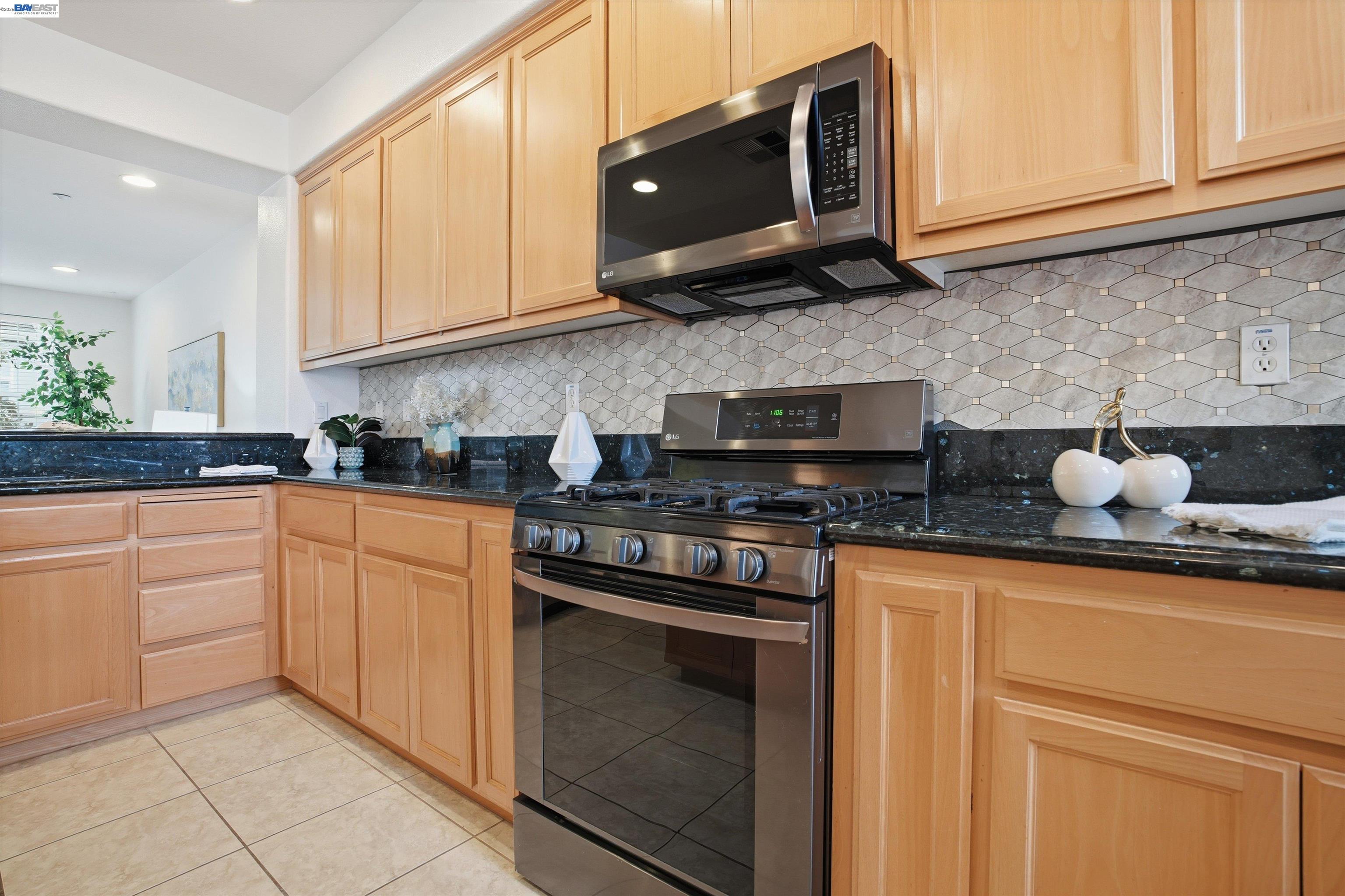 2833 Alnwick Avenue, Unit 7 Livermore, CA 94551 - Photo 20 of 37 a kitchen with stainless steel appliances granite countertop white cabinets sink and stove