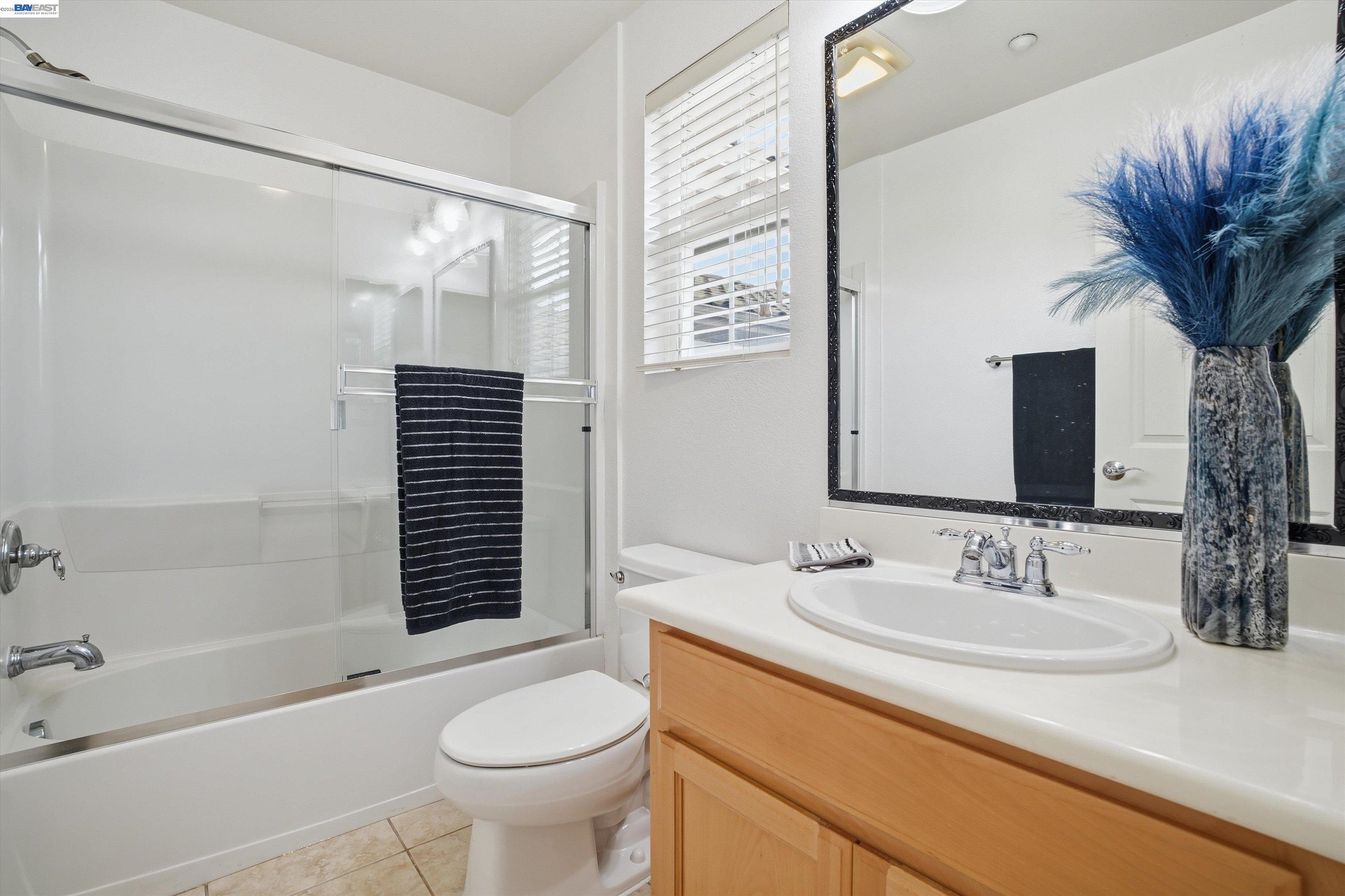 2833 Alnwick Avenue, Unit 7 Livermore, CA 94551 - Photo 26 of 37 a bathroom with a granite countertop sink toilet and shower