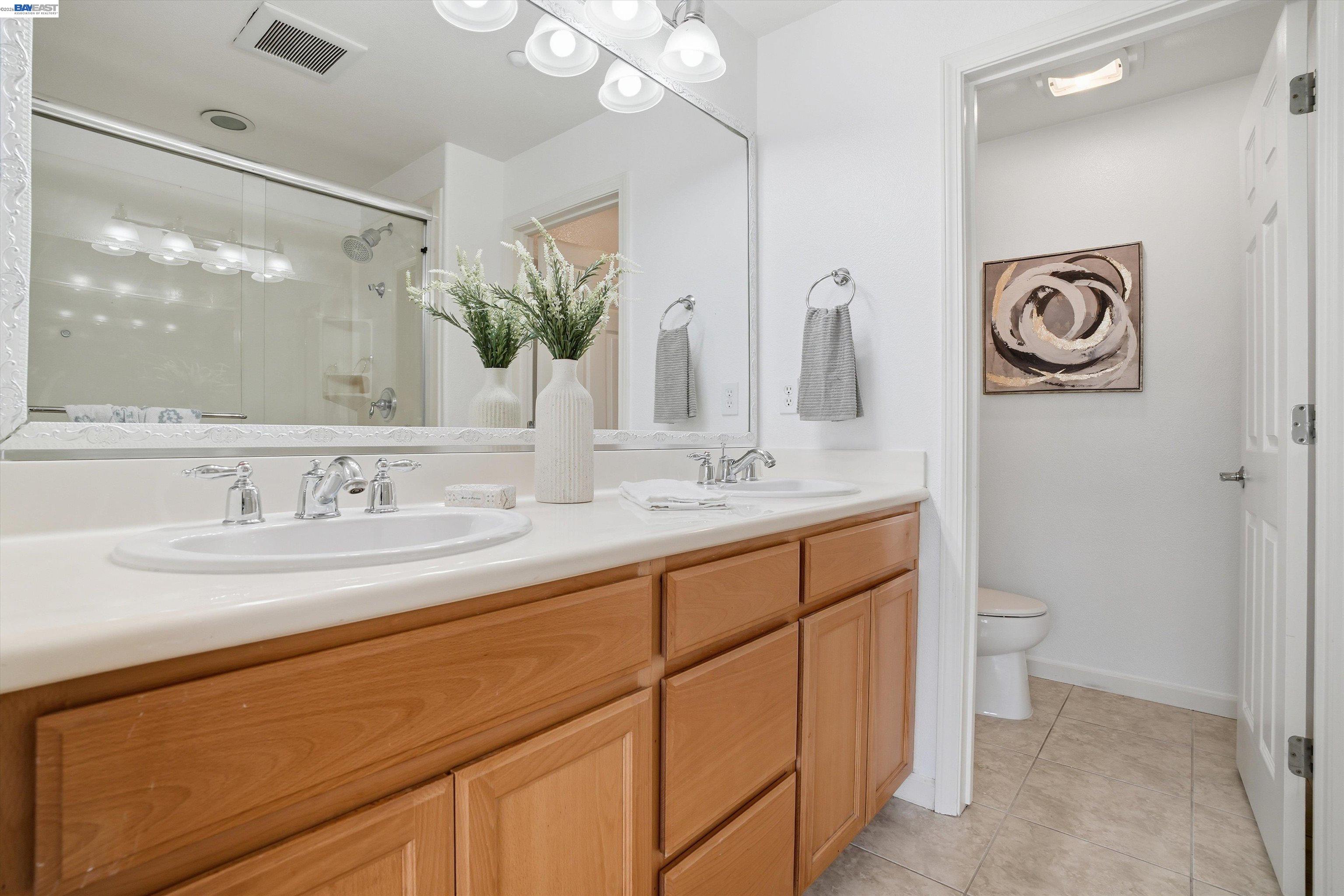 2833 Alnwick Avenue, Unit 7 Livermore, CA 94551 - Photo 31 of 37 a bathroom with a double vanity sink and a mirror