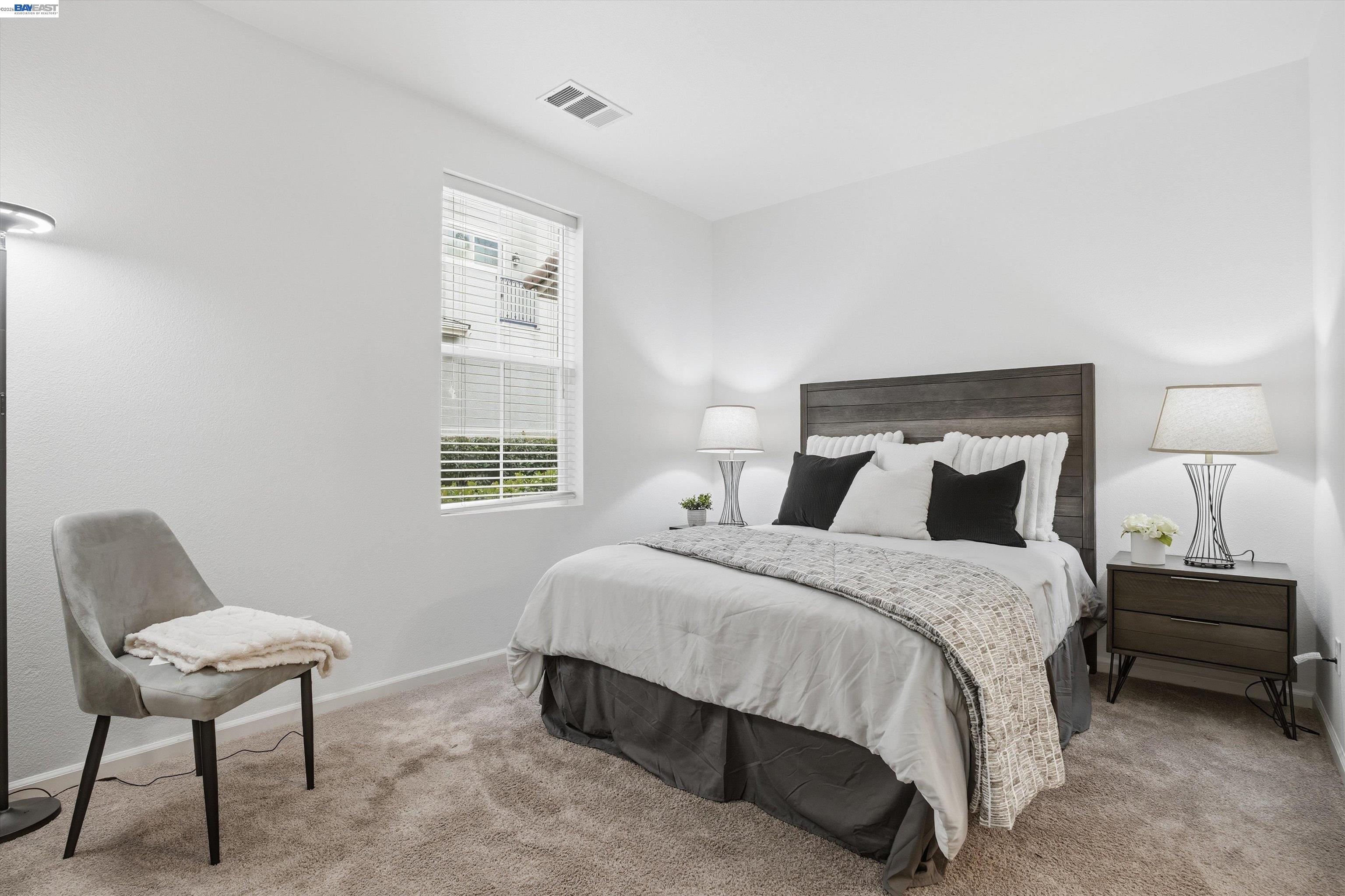 2833 Alnwick Avenue, Unit 7 Livermore, CA 94551 - Photo 5 of 37 a bedroom with a bed a chair and next to a window