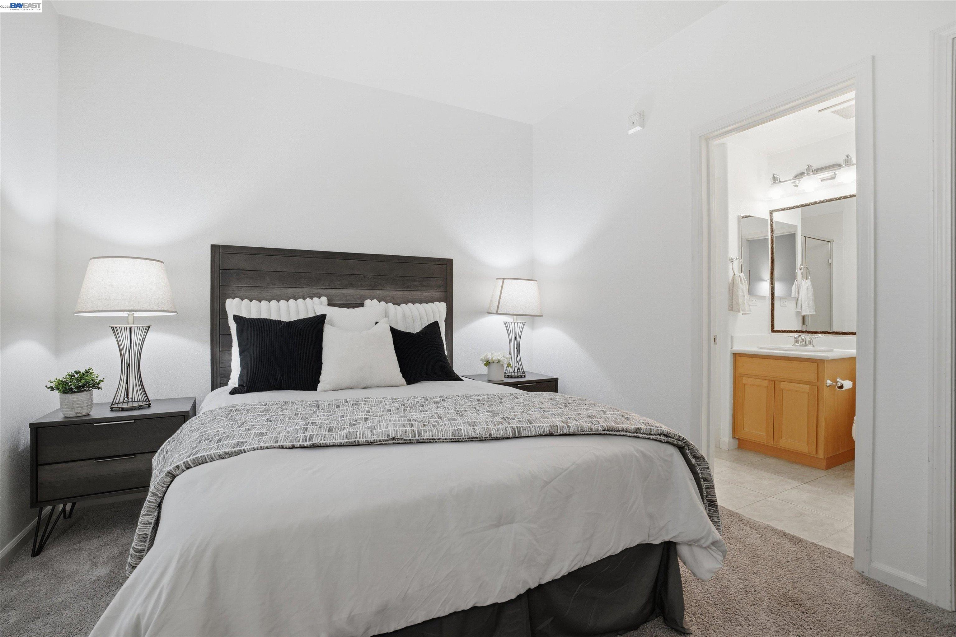 2833 Alnwick Avenue, Unit 7 Livermore, CA 94551 - Photo 6 of 37 a bed sitting in a bedroom with a lamp