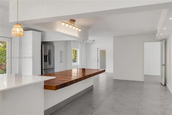a view of livingroom with kitchen island dining table and windows