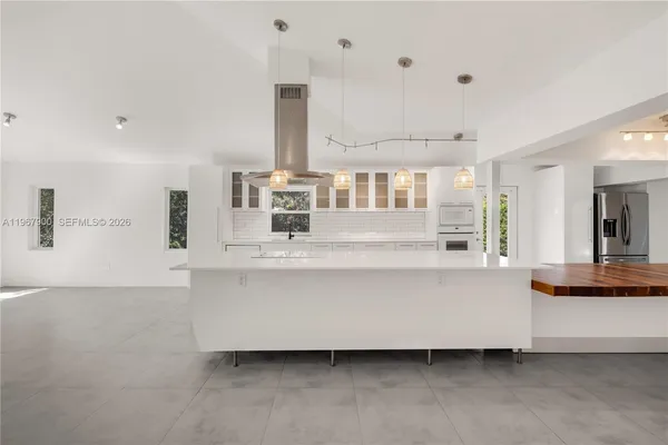 a living room with kitchen island granite countertop furniture and a fireplace
