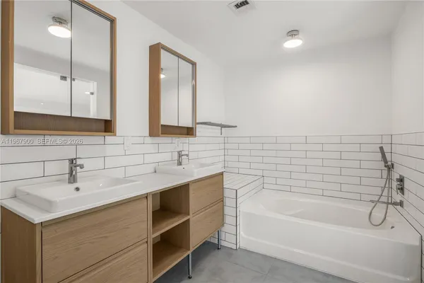 a bathroom with a bathtub and a sink