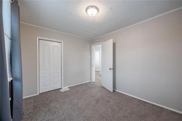 a view of an empty room and a window