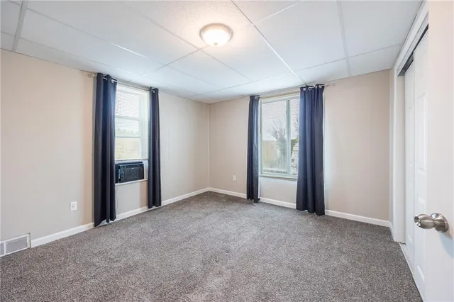 an empty room with windows and closet