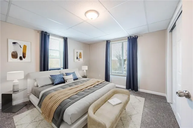 a bedroom with a large bed and a window