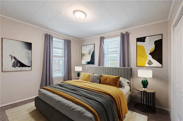 a bedroom with a bed and painting on the wall