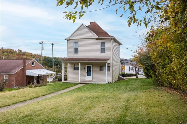 a aerial view of a house with a yard