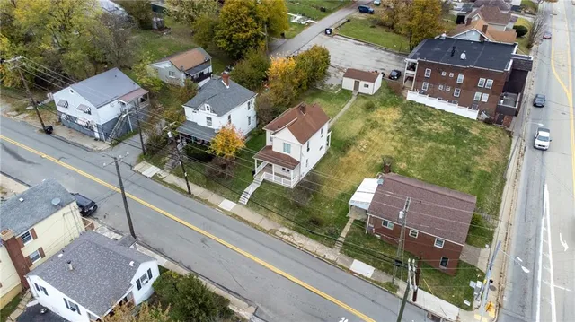 an aerial view of residential houses with outdoor space