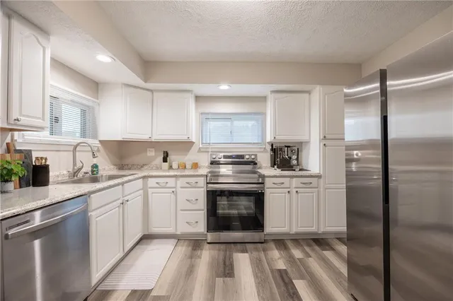 a kitchen with a sink stove and refrigerator