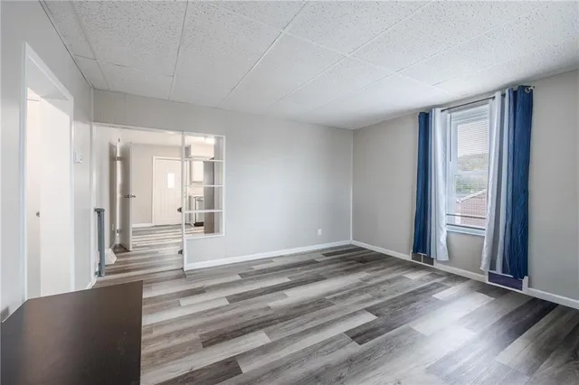 a view of a room with wooden floor and windows