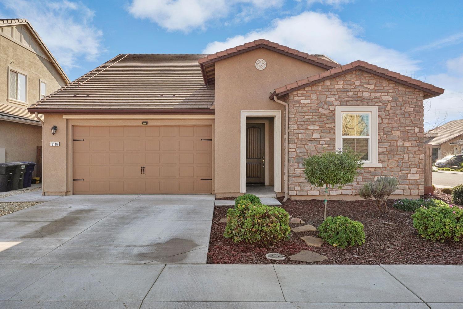 a front view of a house with garden