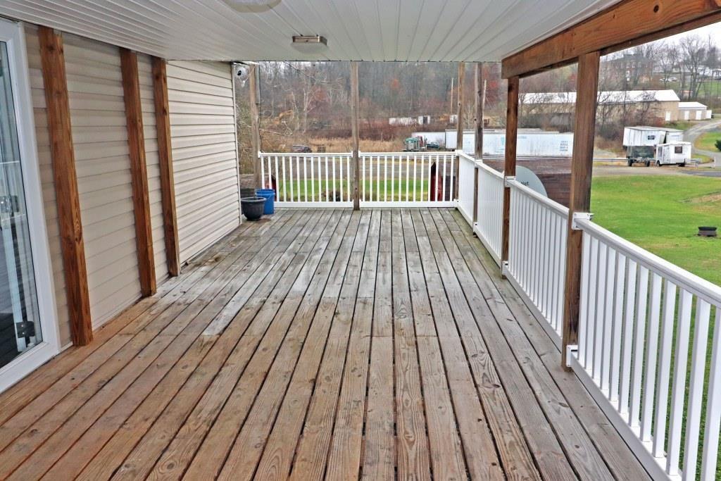 253 Wardentown Road Alverton, PA 15612 - Photo 14 of 18 a view of a wooden deck with a yard