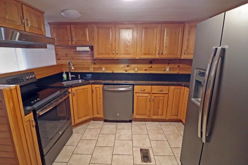 253 Wardentown Road Alverton, PA 15612 - Photo 3 of 18 a kitchen with stainless steel appliances granite countertop a stove a sink and a refrigerator