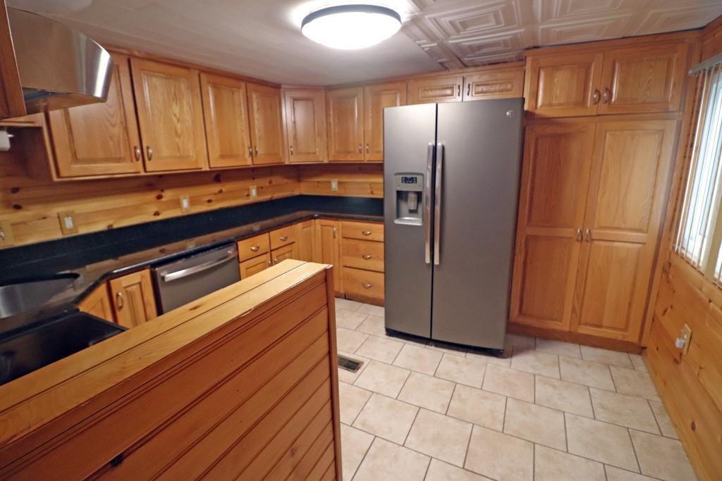 253 Wardentown Road Alverton, PA 15612 - Photo 4 of 18 a kitchen with stainless steel appliances granite countertop a refrigerator and a stove
