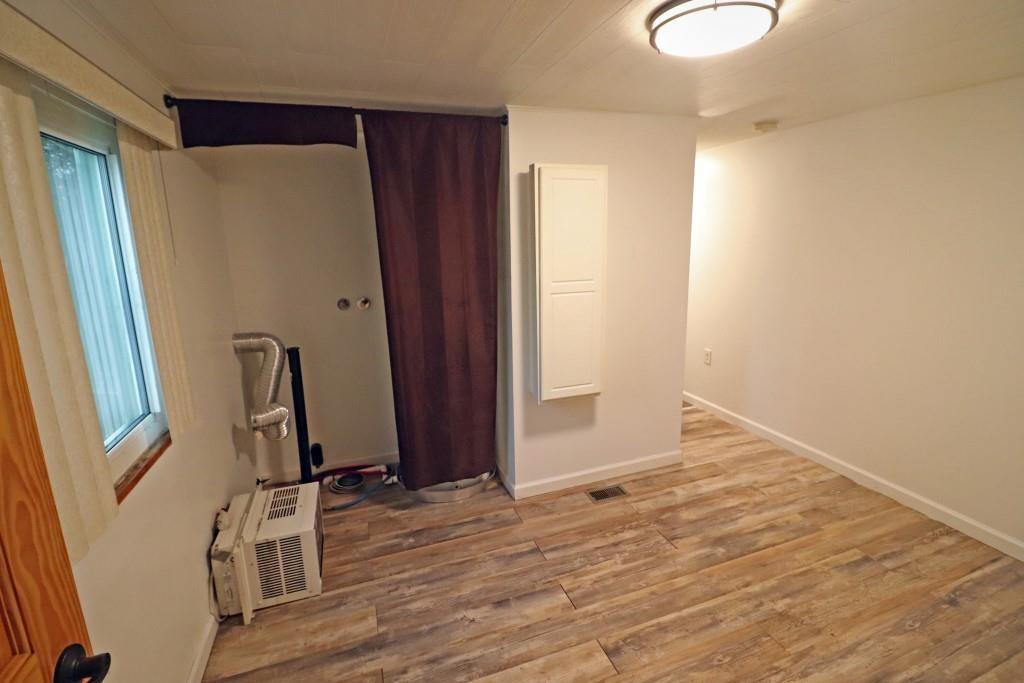 253 Wardentown Road Alverton, PA 15612 - Photo 8 of 18 a view of a hallway with wooden floor and stairs