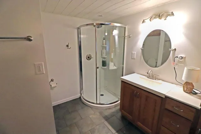 a bathroom with a toilet a sink and mirror