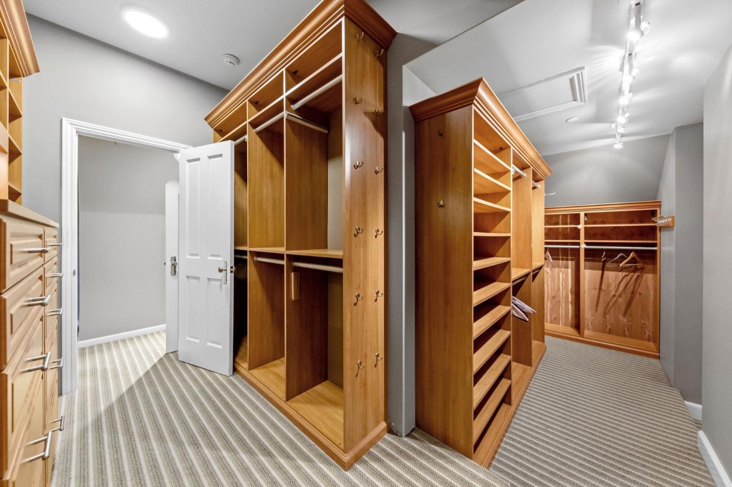 1600 Marlborough Road Hillsborough, CA 94010 - Photo 100 of 111 a view of walk in closet with wooden floor and windows