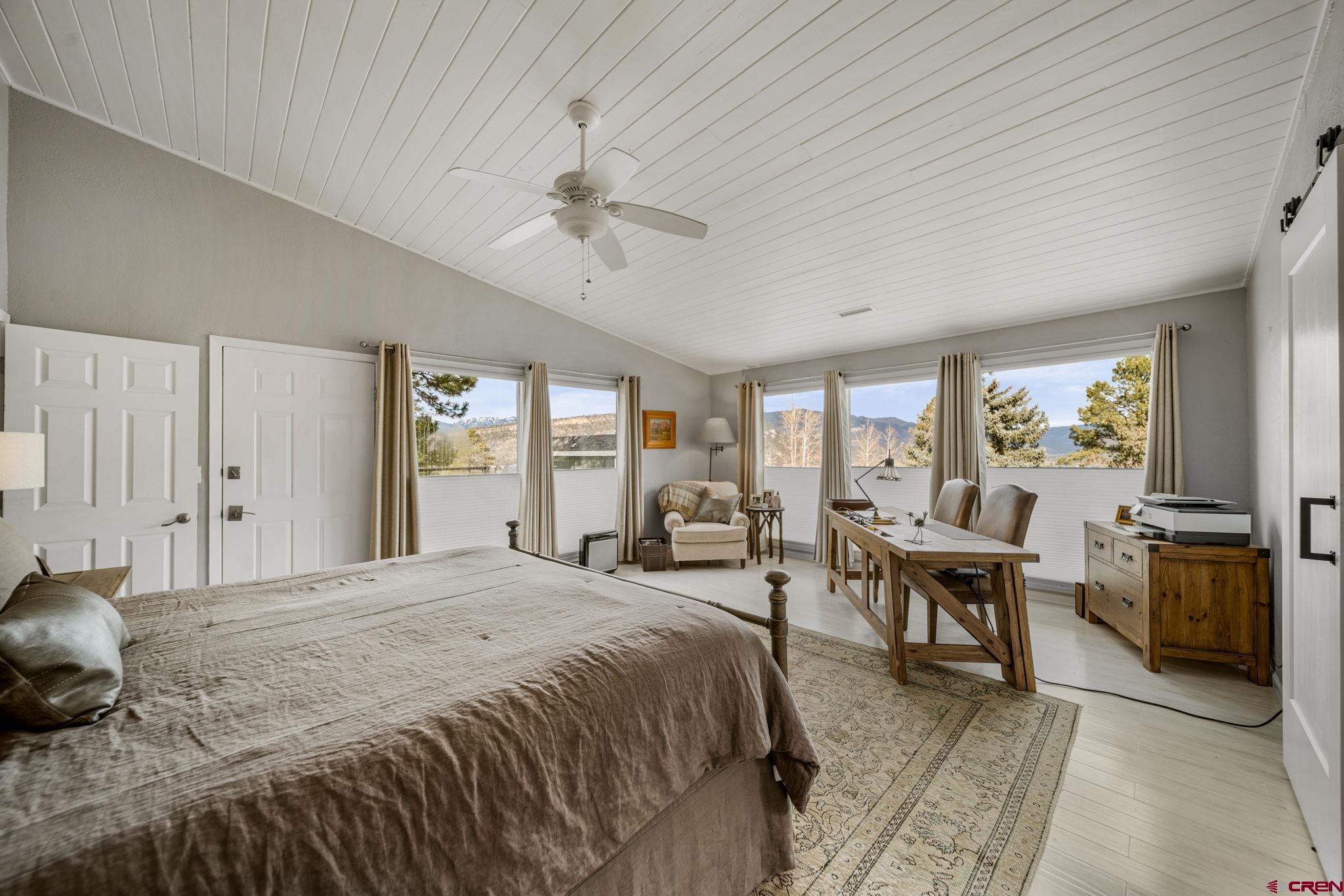 25 Highland Place Durango, CO 81301 - Photo 11 of 40 a spacious bedroom with a bed a table and chair