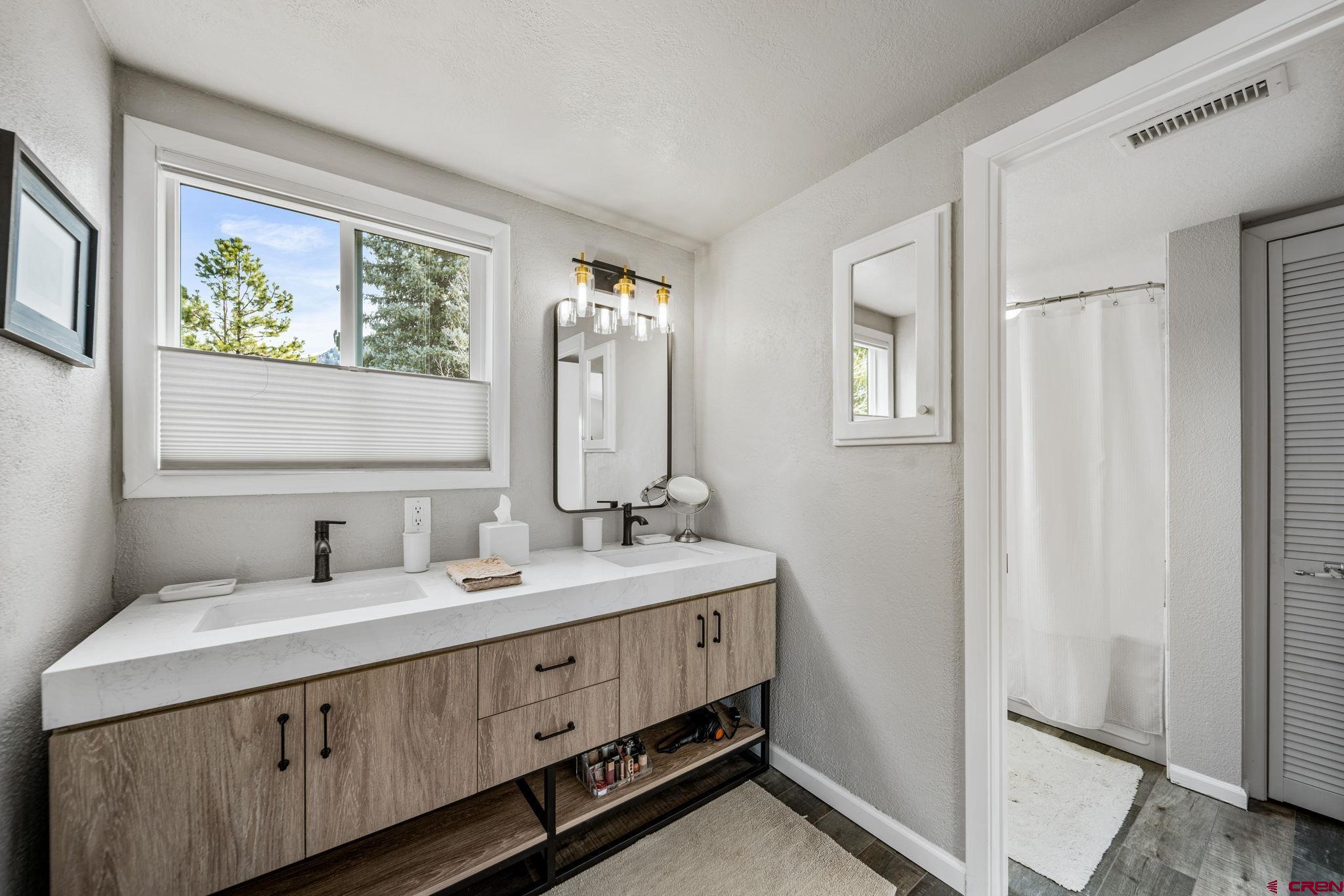 25 Highland Place Durango, CO 81301 - Photo 13 of 40 a bathroom with a double vanity sink and a mirror