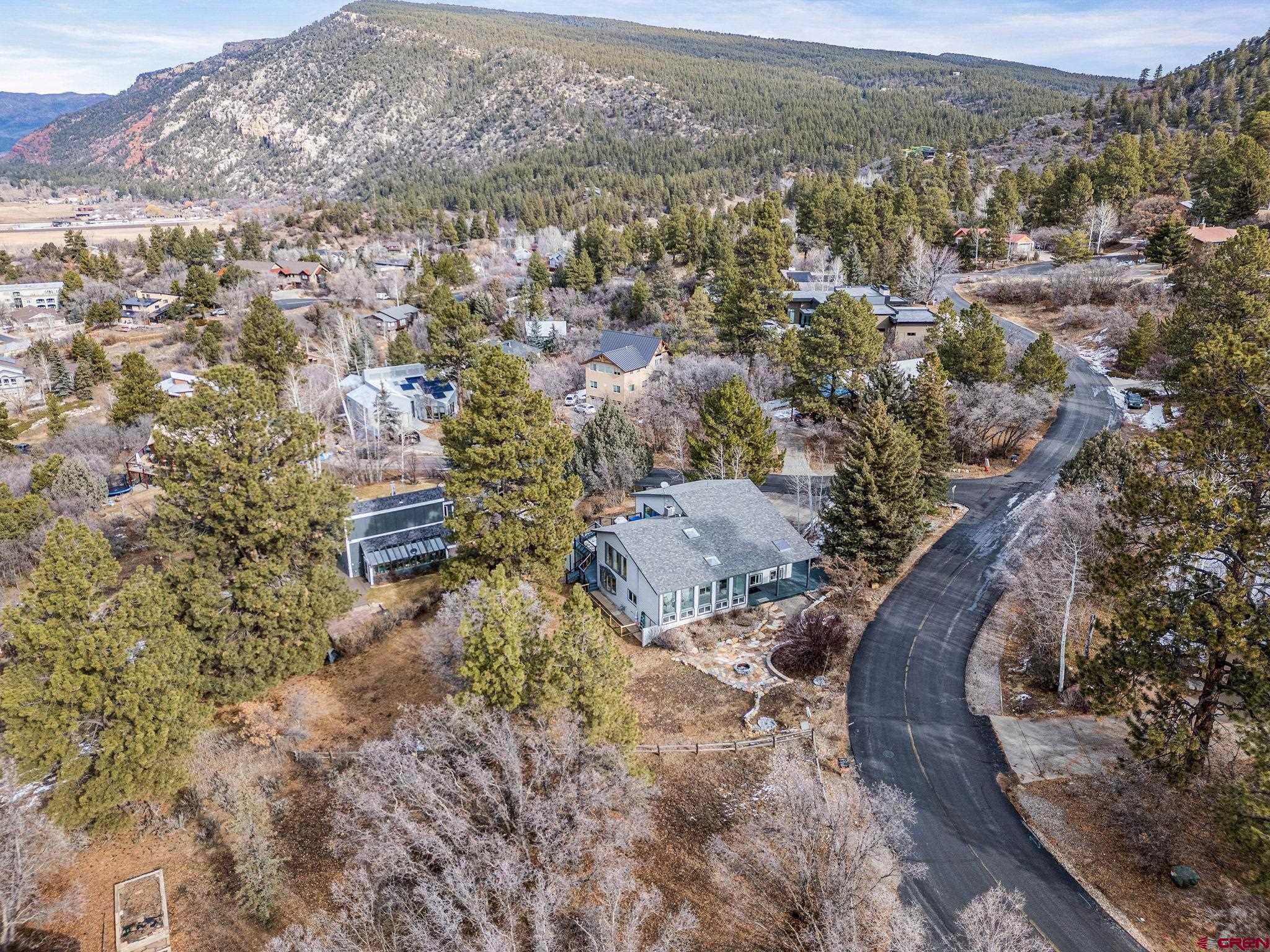 25 Highland Place Durango, CO 81301 - Photo 2 of 40 an aerial view of a house with a yard and mountain view