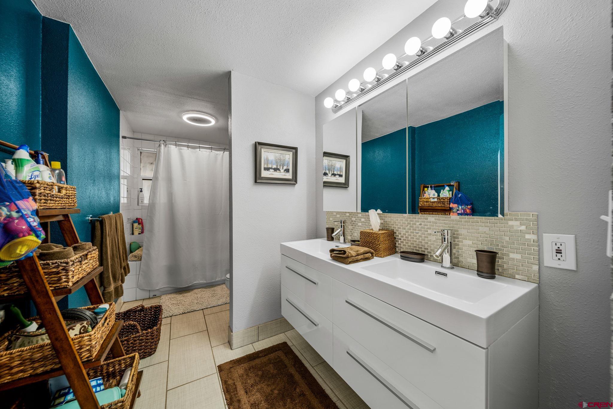 25 Highland Place Durango, CO 81301 - Photo 27 of 40 a bathroom with a sink vanity and a mirror
