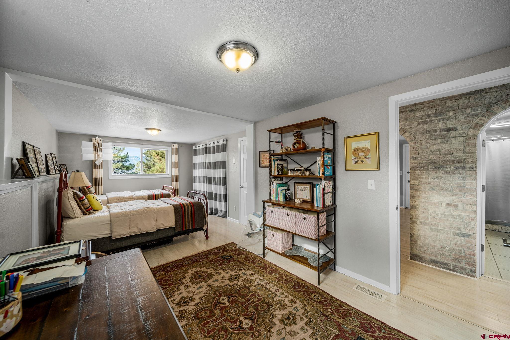 25 Highland Place Durango, CO 81301 - Photo 28 of 40 a bedroom with furniture and a rug