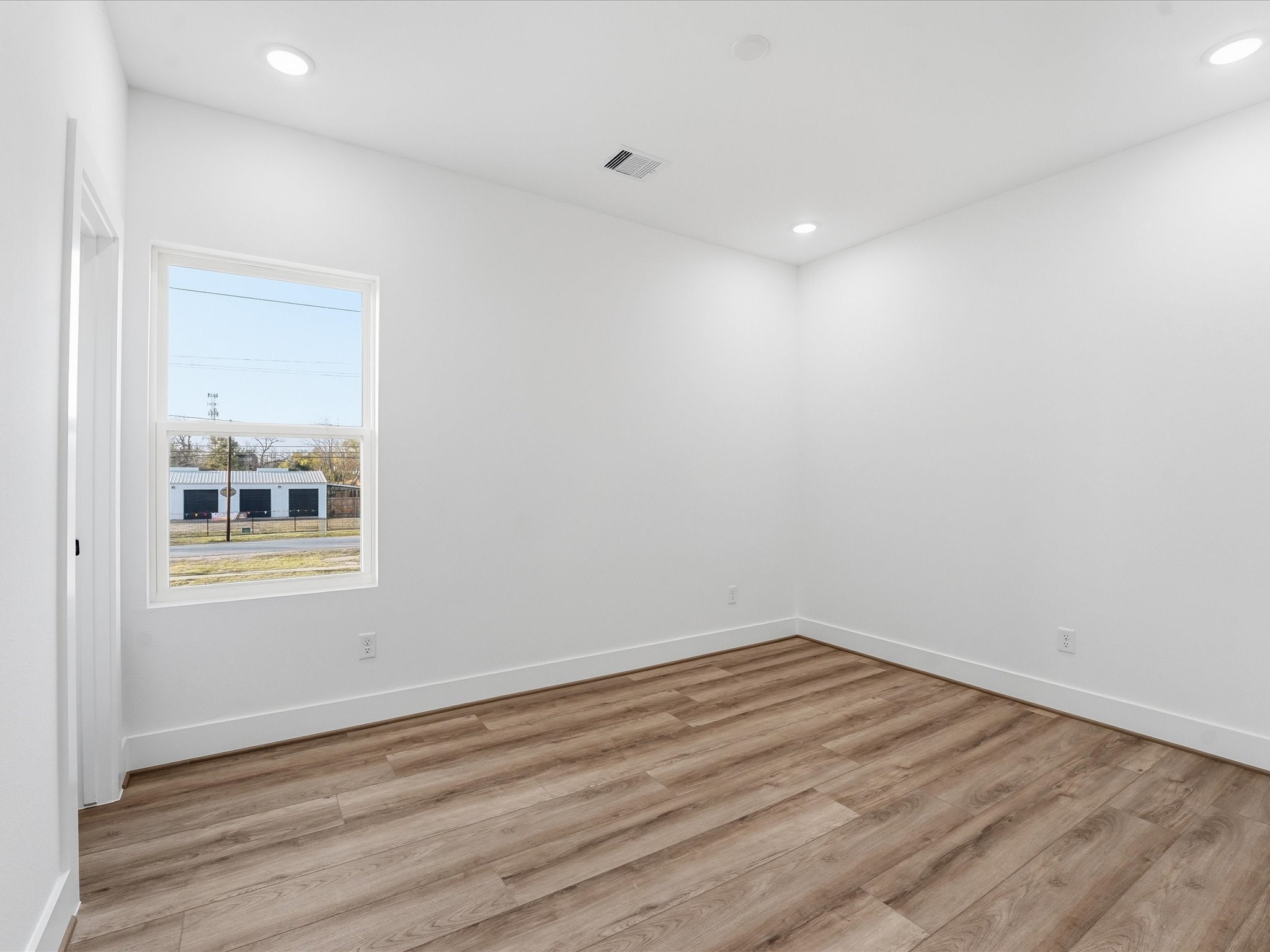 2604-2606 Winbern Street Houston, TX 77004 - Photo 20 of 28 an empty room with wooden floor and windows
