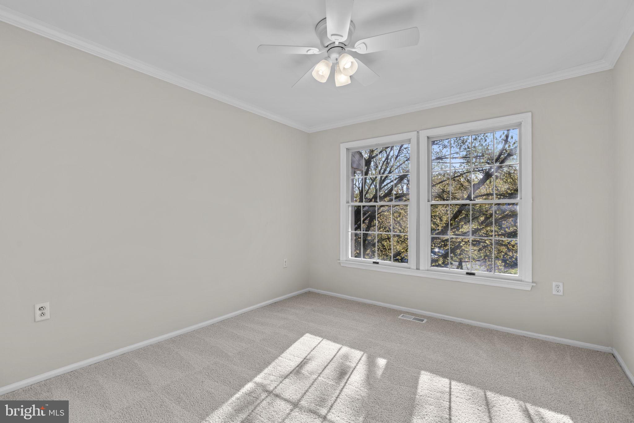 7525 Swan Point Way, Unit 195 Columbia, MD 21045 - Photo 20 of 30 an empty room with windows and ceiling fan