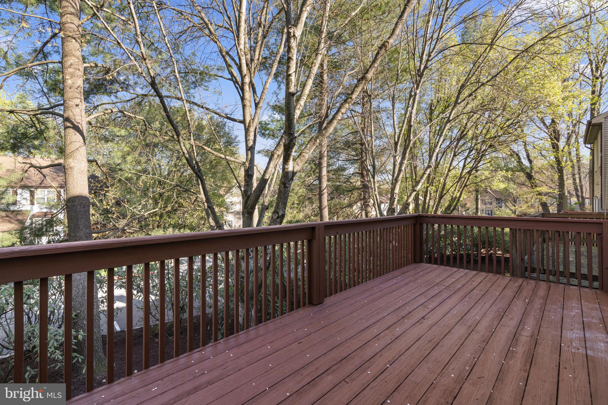 7525 Swan Point Way, Unit 195 Columbia, MD 21045 - Photo 28 of 30 a balcony with wooden floor and trees