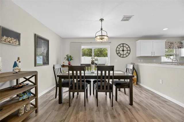 a kitchen with stainless steel appliances granite countertop a stove refrigerator and a sink