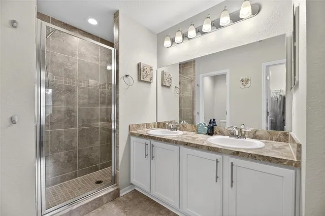 a view of walk in closet with clothes