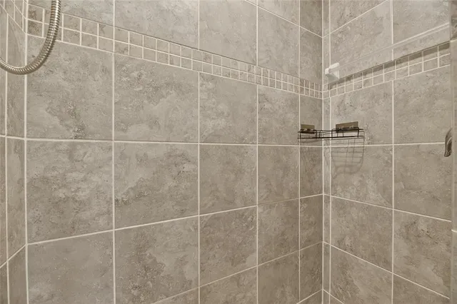 a bedroom with a large bed and a ceiling fan