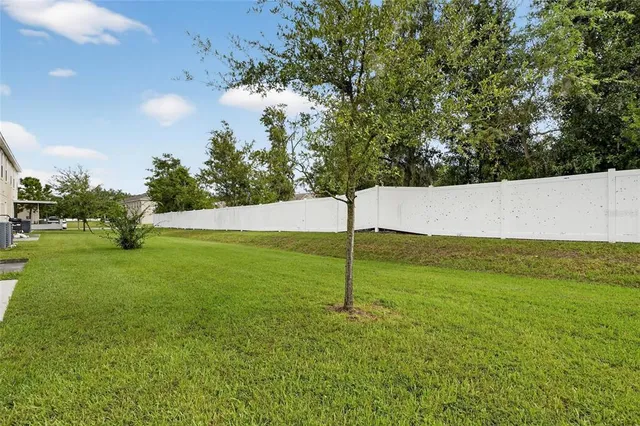 an aerial view of a house with a big yard