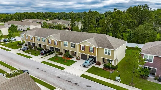 an aerial view of a house with swimming pool outdoor seating and yard