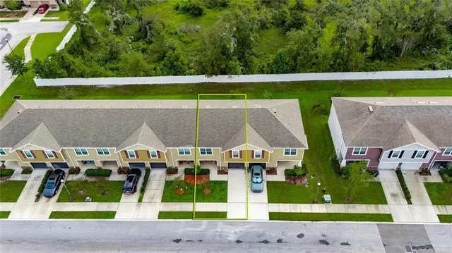 an aerial view of a house with a garden and lake view