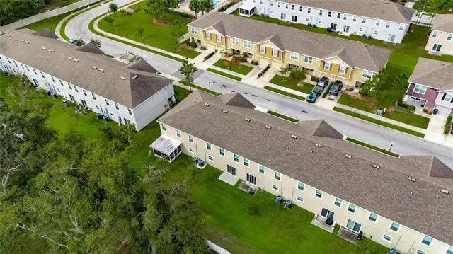 an aerial view of a house with a yard