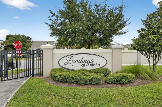 an aerial view of a residential houses with yard