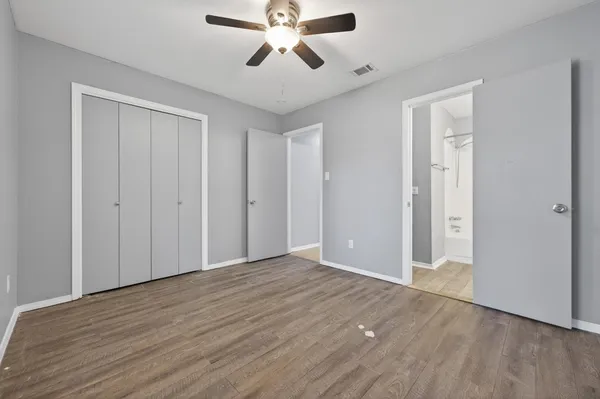 a view of empty room with wooden floor