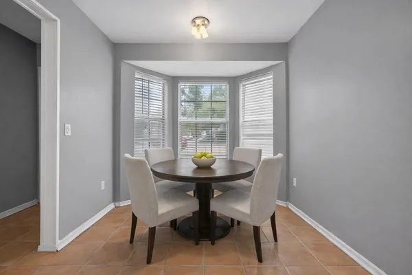 a view of a room with a table and chairs