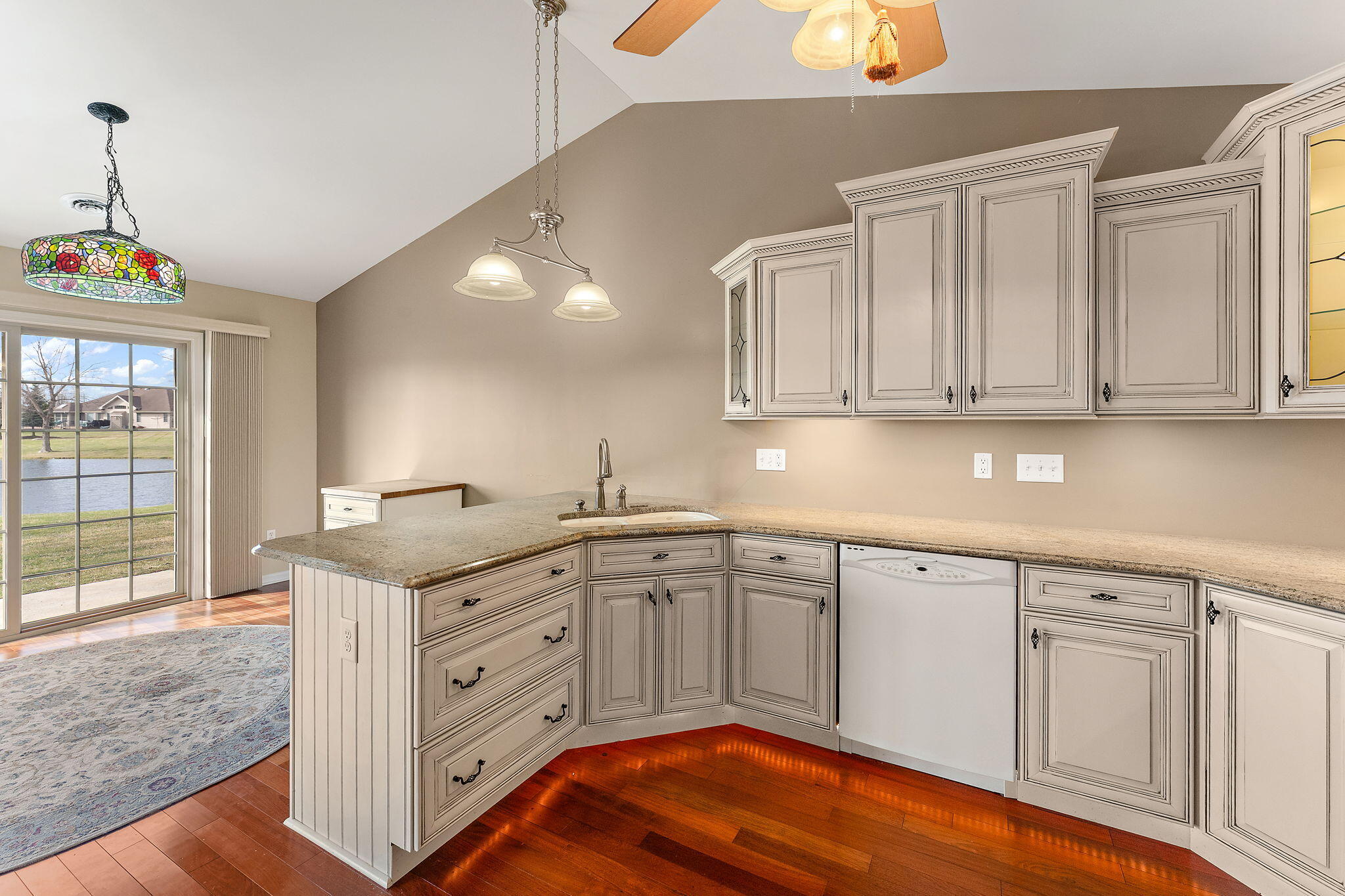 901 Veterans Lane Crown Point, IN 46307 - Photo 13 of 40 a kitchen with granite countertop white cabinets and white appliances
