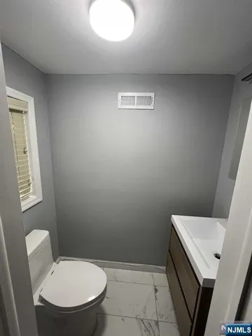 a bathroom with a toilet and a sink
