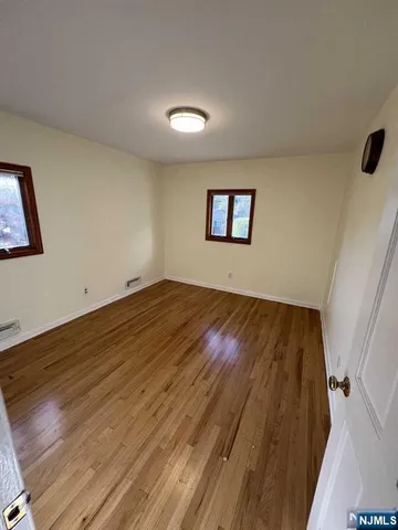 a room with a sink a mirror and a window