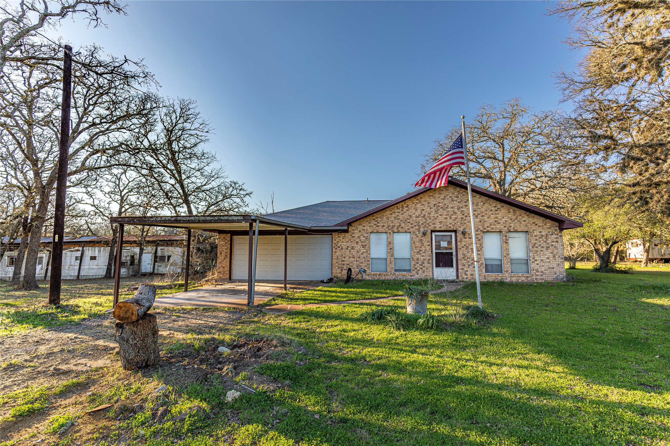 125 Forrest Lane Brenham, TX 77833 - Photo 2 of 21 a front view of a house with a yard