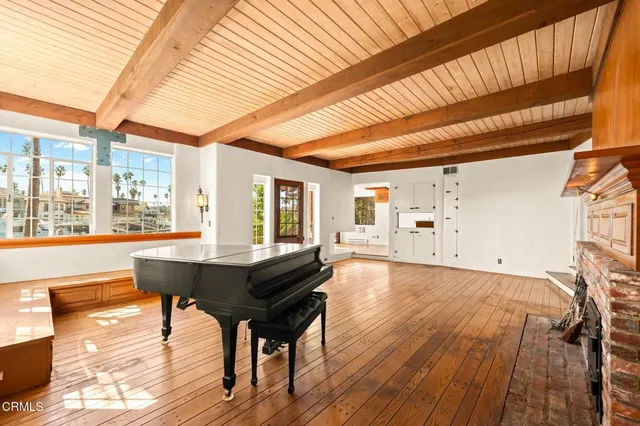 a living room with furniture and large windows