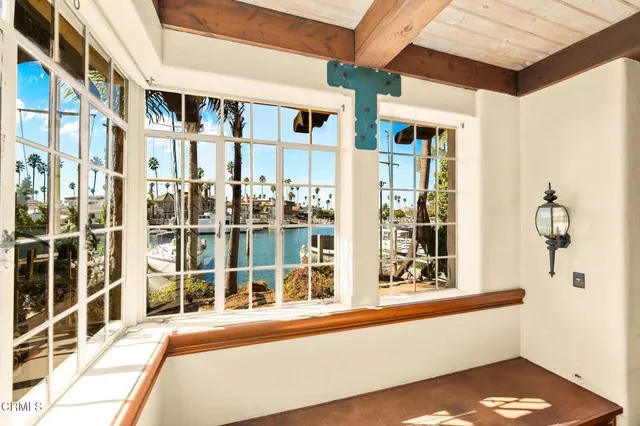 a view of hallway with wooden floor and furniture