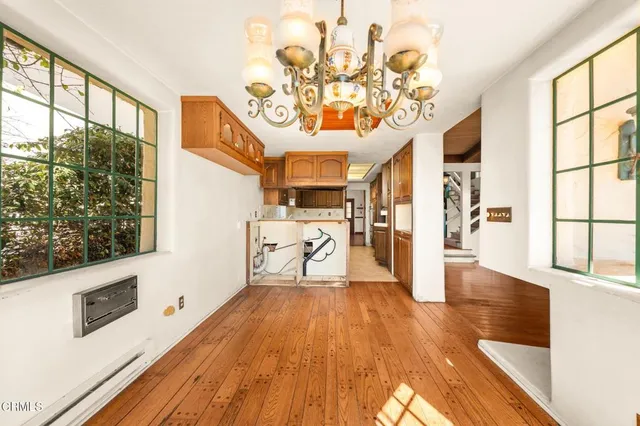a kitchen with a sink a stove and cabinets