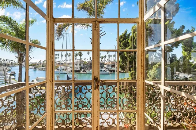 a view of a livingroom with a chandelier fan and closet