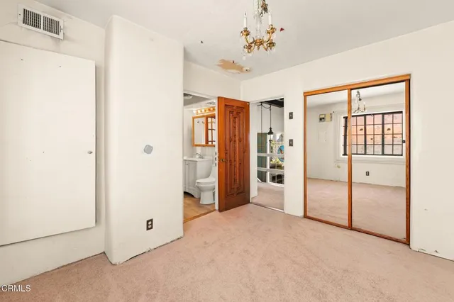 a view of a chair and tables in the patio